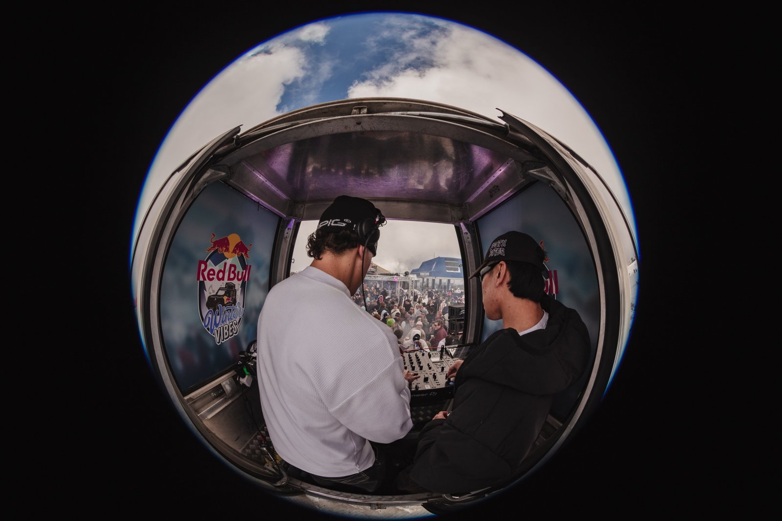 Fisheye view of two DJs inside the Red Bull gondola booth